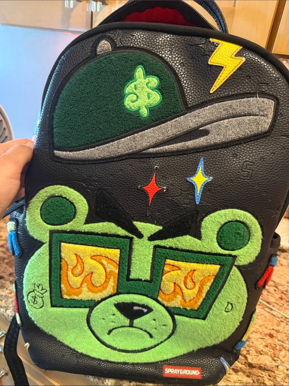 Sprayground Black Backpack with Neon Green Bear Patch and Multicolor Accents